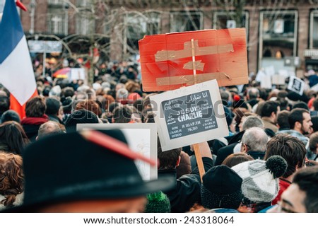 STRASBOURG, FRANCE - 11 JAN, 2015: People hold placards reading \'Je suis Charlie\' during a unity rally (Marche Republicaine) where some 50000 took part in tribute three-day killing spree in Paris