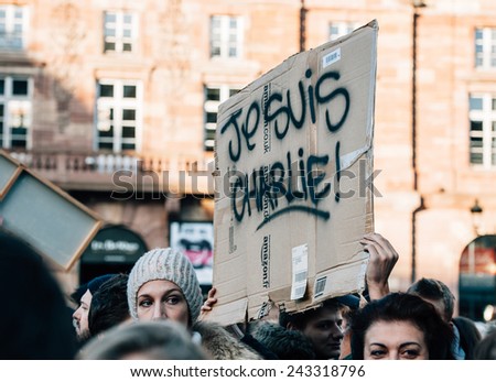 STRASBOURG, FRANCE - 11 JAN, 2015:  People hold placards reading \'Je suis Charlie\' during a unity rally (Marche Republicaine) where some 50000 took part in tribute three-day killing spree in Paris
