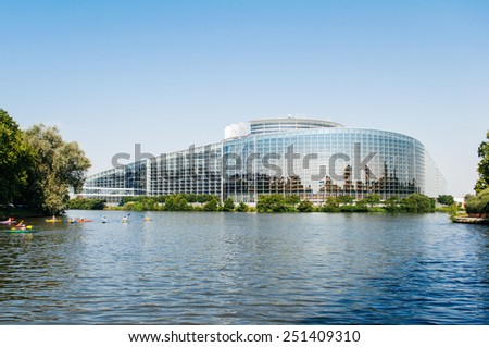 STRASBOURG, FRANCE - JUNE 29: South facade of the European Parliament in Strasbourg, France on June 29 2010 with the intersection of the Ill and Marne-Rhine Canal and canoes.