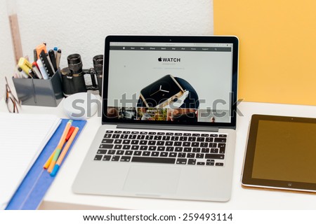 PARIS, FRANCE - MAR 10, 2015: Apple Computers website on MacBook Retina in room environment showcasing Apple Watch launch date as seen on 10 March, 2015