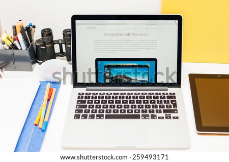 PARIS, FRANCE - MAR 10, 2015: Apple Computers website on MacBook Retina in room environment showcasing MacBook as compatible with Microsoft Windows as seen on 10 March, 2015