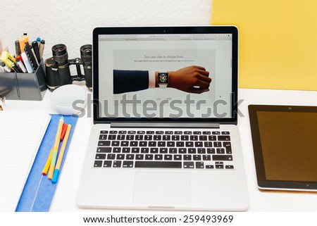 PARIS, FRANCE - MAR 10, 2015: Apple Computers website on MacBook Retina in room environment showcasing Apple Watch two sizes on hand as seen on 10 March, 2015