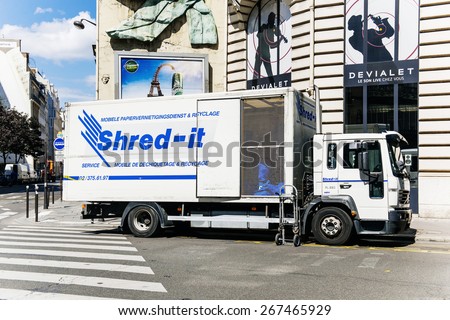 PARIS, FRANCE - AUG 18, 2014: Shred-it truck shredder outside client\'s door on Paris street. Shred-it specializes in mobile on-site and off-site secure paper shredding and confidential waste disposal