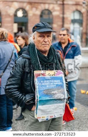STRASBOURG, FRANCE - APR 26 2015: Man with placard at protest against immigration policy and border management which asks for commitment in the wake of migrants boat disasters