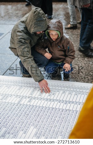 STRASBOURG, FRANCE - APR 26 2015: Dad and son at protest against immigration policy and border management which asks for commitment in the wake of migrants boat disasters
