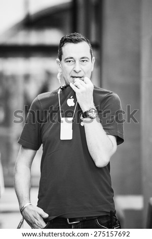 STRASBOURG, FRANCE - SEPTEMBER 19, 2014: Apple sales manager talking via walkie-talkie in Apple Store with his colleague