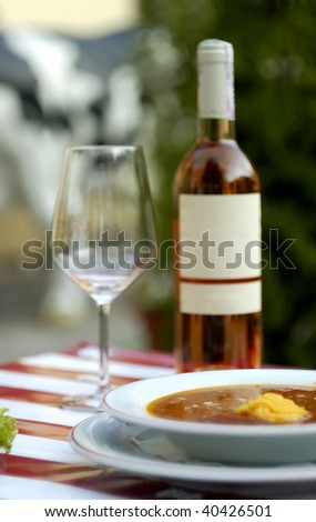 Vegetable soup and expensive wine at restaurant (shallow dof)