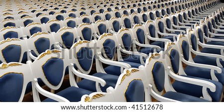Empty chairs at cinema, opera or theater, blue tone and gold decorations