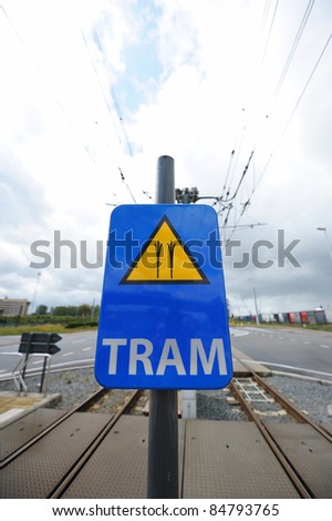 Road sign warning tram crosses. Useful file for your brochure about safety on the road.