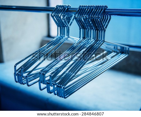 Metallic coat hangers on clothes rail - empty closet