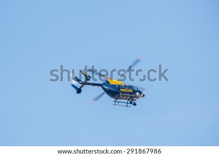 LONDON, UNITED KINGDOM - AUGUST 28, 2013: Police helicopter flying against a clear blue sky on a summer day