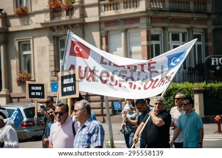 STRASBOURG, FRANCE - JULY 11, 2015: Uyghur human rights activists participate in a demonstration to protest against Chinese government\'s policy in Uyghur