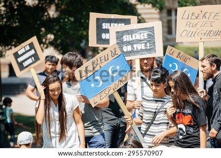 STRASBOURG, FRANCE - JULY 11, 2015: The blue of hope placard - Uyghur human rights activists participate in a demonstration to protest against Chinese government\'s policy in Uyghur