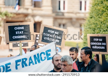 STRASBOURG, FRANCE - JULY 11, 2015: Stop Uyghur genocide -  Uyghur human rights activists participate in a demonstration to protest against Chinese government\'s policy in Uyghur