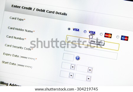LONDON, UNITED KINGDOM - MARCH 16, 2014: Electronic payment process field seen on computer screen with mouse over Visa Debit signage