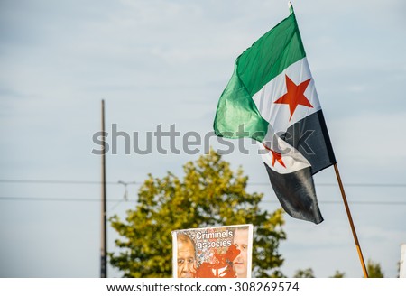 STRASBOURG, FRANCE - AUG 20, 2015: People protesting in front of European Parliament denouncing the Syrian airstrikes on Douma wheremore 80 were killed - Assad and Lavrov killers and Syrian flag