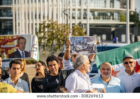 STRASBOURG, FRANCE - AUG 20, 2015: People protesting in front of European Parliament denouncing the Syrian airstrikes on Douma wheremore 80 were killed - Sergey lavrov killer placard