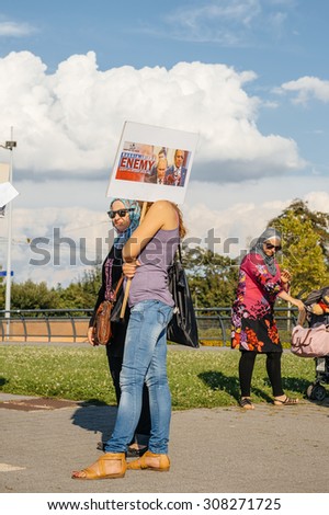STRASBOURG, FRANCE - AUG 20, 2015: People protesting in front of European Parliament denouncing the Syrian airstrikes on Douma wheremore 80 were kille - Russia is the enemy placard
