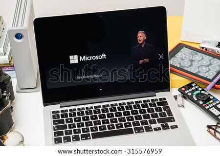 PARIS, FRANCE - SEP 10, 2015: Apple Computers website on MacBook Pro Retina in a creative room environment showcasing Apple Top management and Microsoft logo