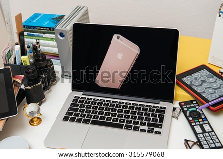PARIS, FRANCE - SEP 10, 2015: Apple Computers website on MacBook Pro Retina in a creative room environment showcasing the newly announced iPhone 6s Plus in golden pink rose