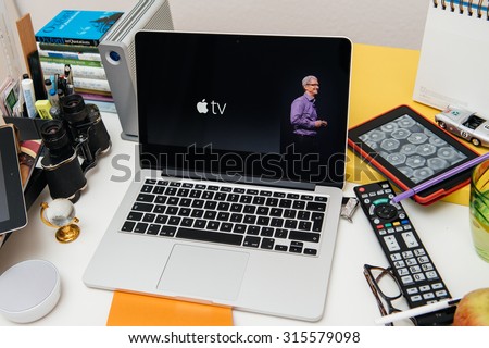 PARIS, FRANCE - SEP 10, 2015: Apple Computers website on MacBook Pro Retina in a creative room environment with Tim Cook and New Apple TV