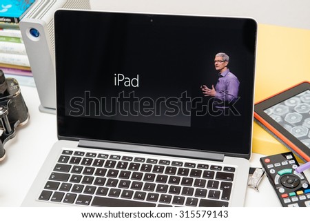 PARIS, FRANCE - SEP 10, 2015: Apple Computers website on MacBook Pro Retina in a creative room environment with Tim Cook and iPad