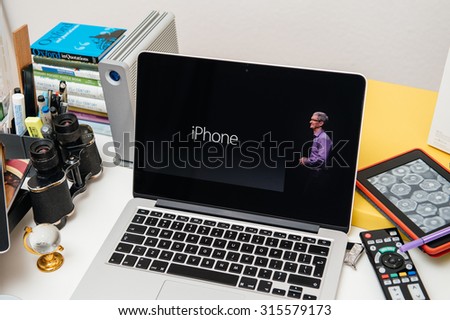 PARIS, FRANCE - SEP 10, 2015: Apple Computers website on MacBook Pro Retina in a creative room environment showcasing Tim Cook and new iPhone