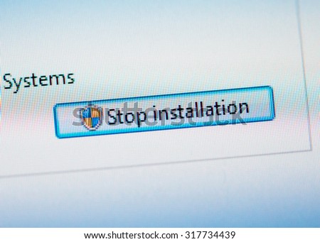 LONDON, UNITED KINGDOM - FEB 26, 2015: Stop installation button on computer display.Tilt-shift lens used to outline the button  and to emphasize the attention on it