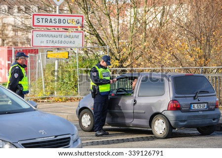 STRASBOURG, FRANCE - NOV 14 2015: French Police checking vehicles on the \'Bridge of Europe\' between Strasbourg and Kehl Germany, as a measure after attacks in Paris - security passport check