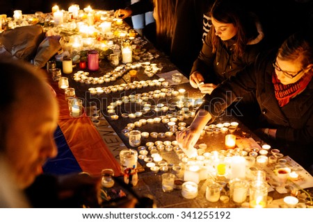 STRASBOURG, FRANCE - NOV 18, 2015: People writing Paris word with candles  in center of Strasbourg, in solidarity for victims and families of the assault in Paris