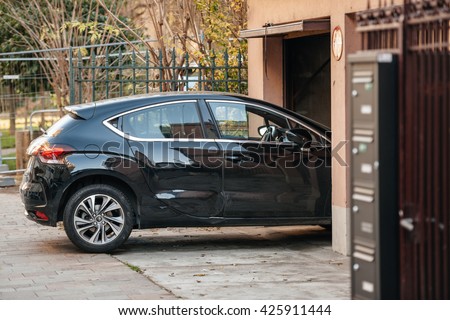 Detail of a car entering through garage door