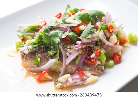 Sardine spicy salad or yum sardine, mixture of red chili, garlic scallion, cilantro red onion lime juice over sardine. \