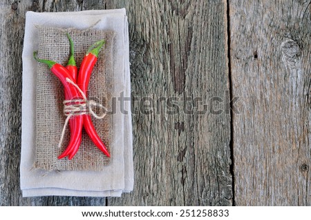Chili pepper on linen texture and wooden table,spice