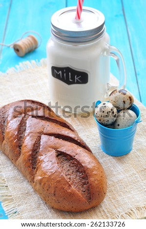 Bread, milk and eggs on a blue background