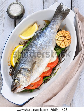 baked fish with herbs, vegetables and garlic, diet food.selective focus