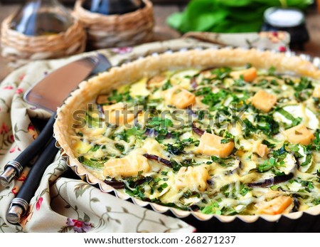 Vegetable pie tart with eggplant, vegetable marrow, soft and hard cheese. selective focus.