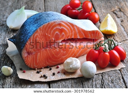 raw salmon steak with cherry tomato, mushroom, onions, dill, garlic, lemon and olive oil