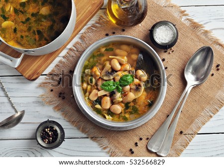 Soup with mushrooms, corn flour, white beans, carrots, onions and parsley.