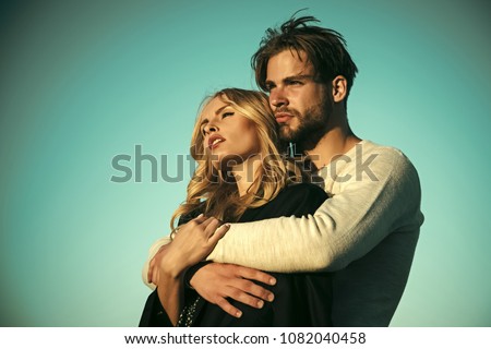 Couple in love. Family couple of man and sexy girl, trust. Muscular man and woman with long blond hair, love. Relations of happy family, future. Couple in love on blue sky background. Love and romance