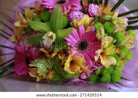 Variegated summer spring bouquet with green, yellow and pink flowers close-up, horizontal picture