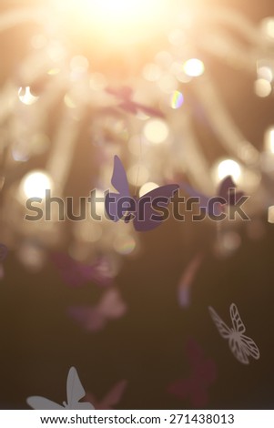 Fine violer decorative butterflies soaring under the light, vertical photo