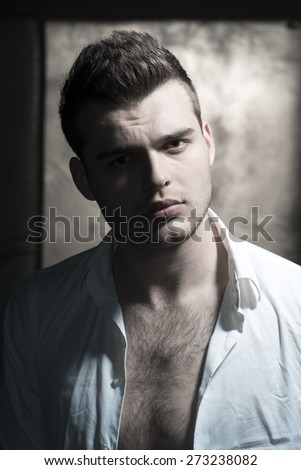Handsome serious young guy, vertical picture