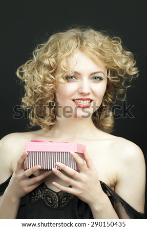 Excited attractive girl opening surprise gift box