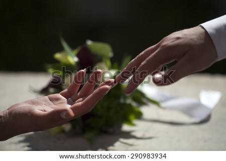 Married couple touching each other with hands on celebration background closeup, horizontal picture