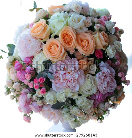 Decorative wedding nosegay of fresh beautiful flowers of roses and peony pink violet purple yellow lilac and orange colours in slim vase isolated on white background, square picture