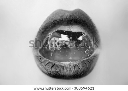 Closeup of sexual open female mouth of beautiful young girl with foam beverage bubbles on soft juicy lips on face black and white, horizontal picture