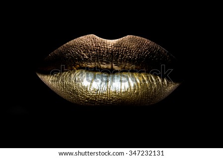 Closeup view of sexual beautiful female closed golden lips isolated on black background, horizontal picture