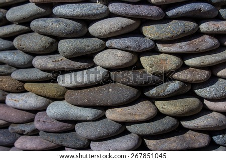 River pebbles stacked on top of each other making a pot.