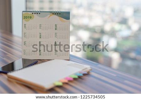 2019 Calendar on table in modern office with diary mobile phone notebook with blurred background. Planning for business year event schedule appointment booking timeline reminder Calendar Concept.