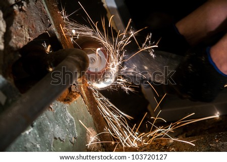 Photo of spinnig circular saw with bunch of sparks